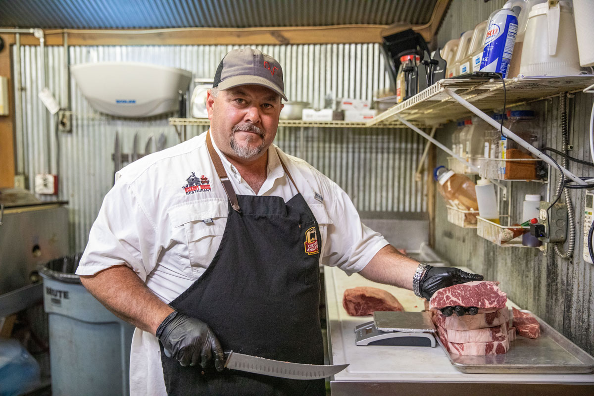 JP cutting steaks at Hickory House