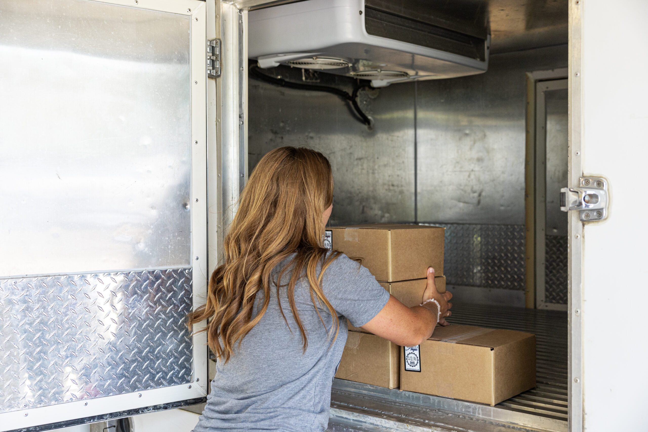 Dakota Angus, Ashley Bruner grabbing freezer beef box