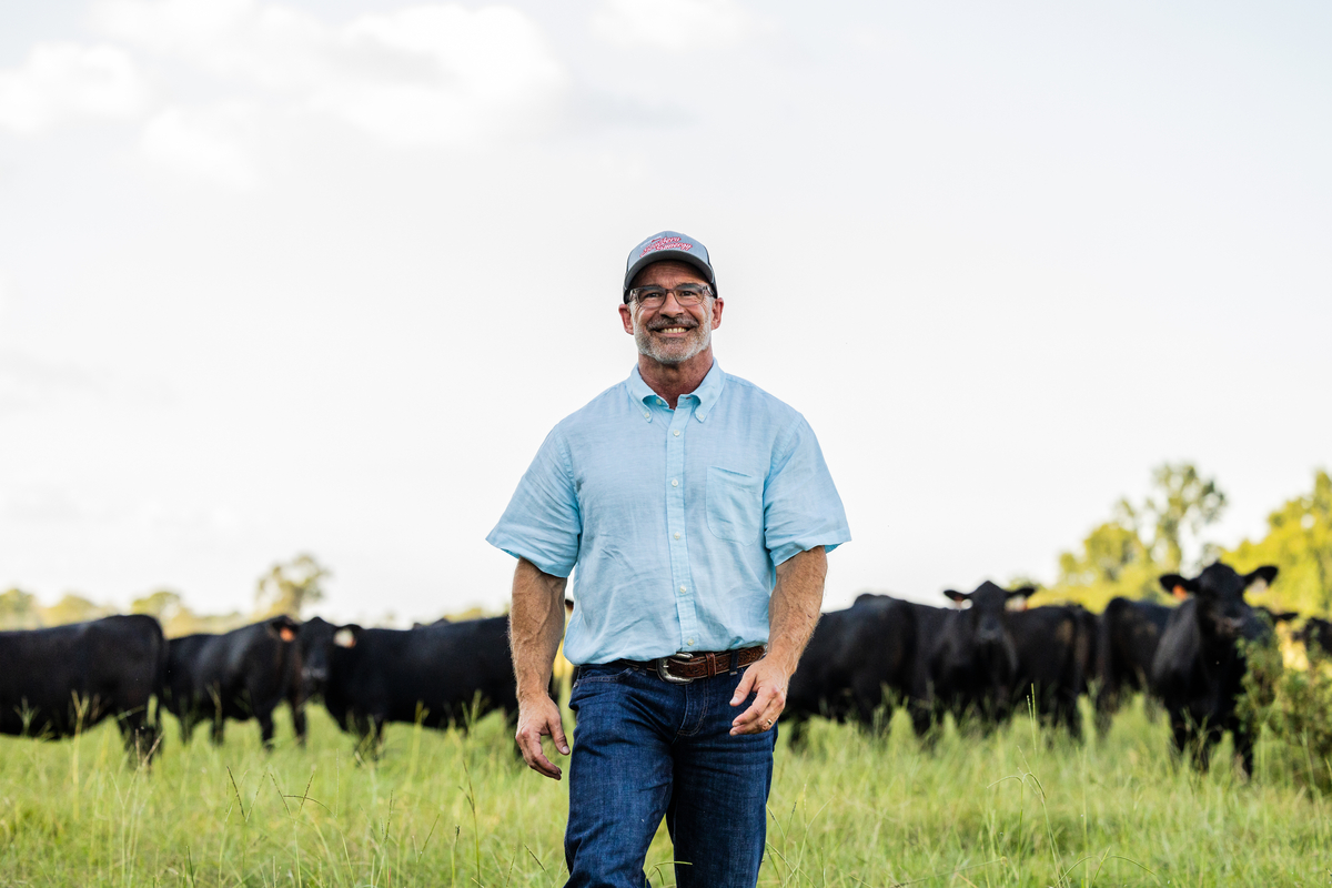 Smitty Lamb walking through his pasture