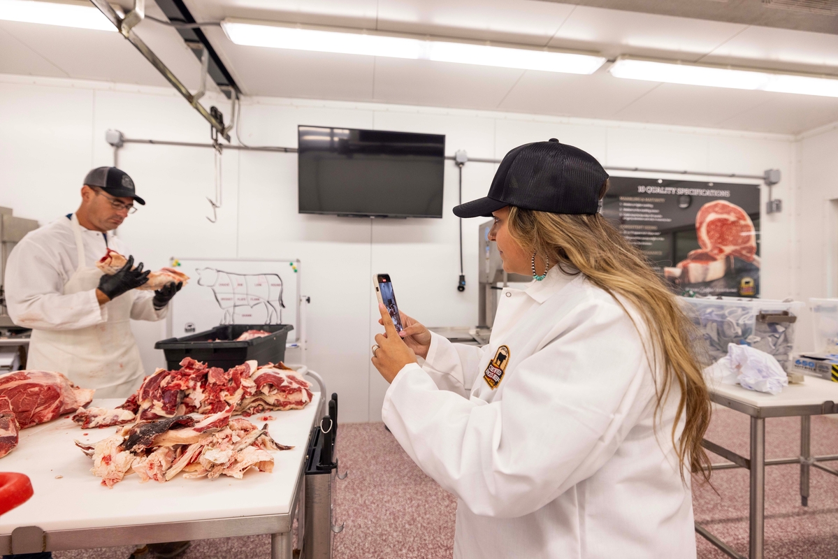 Alex Ramirez, social media intern, taking photos in the meat lab