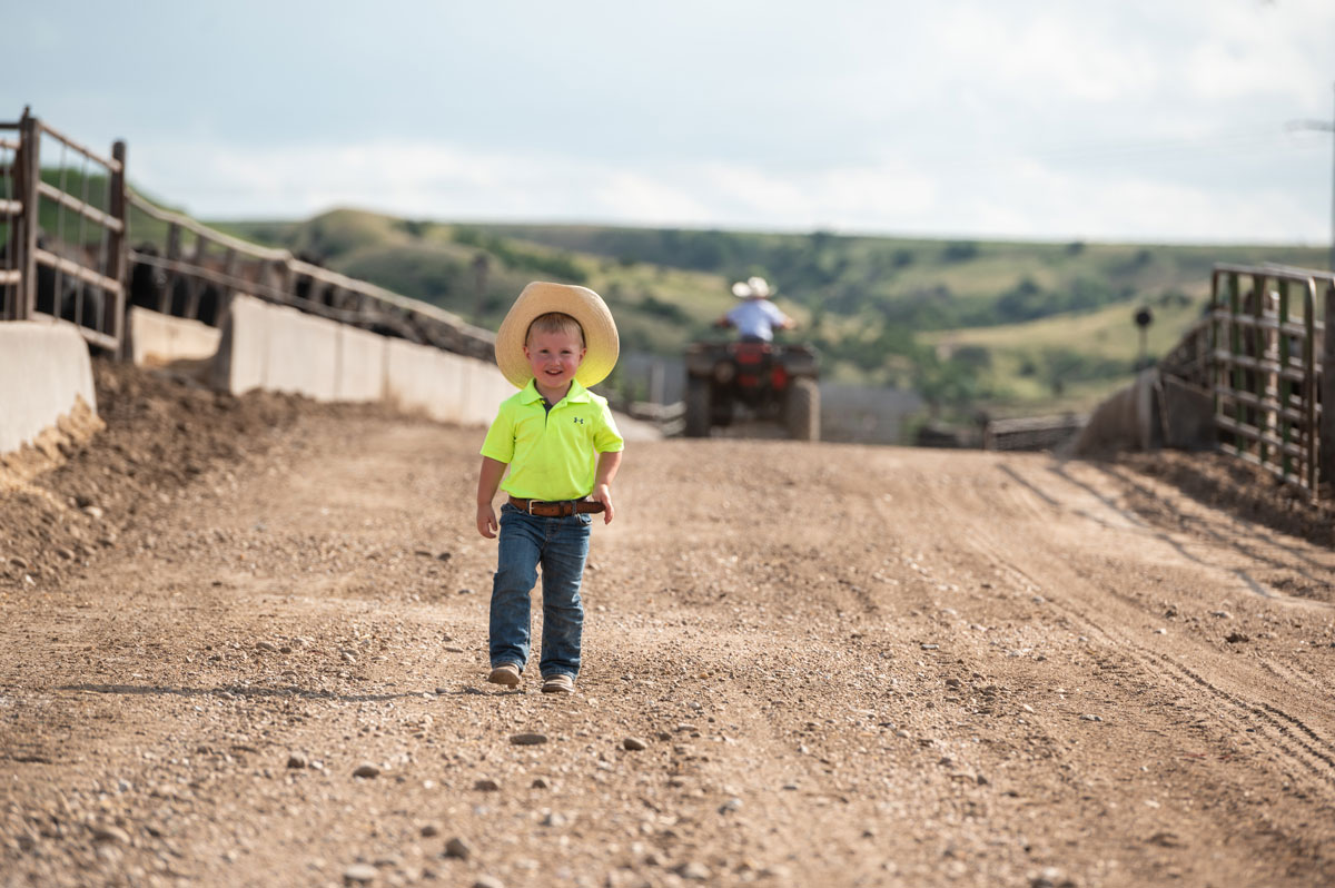 little boy in feedyard